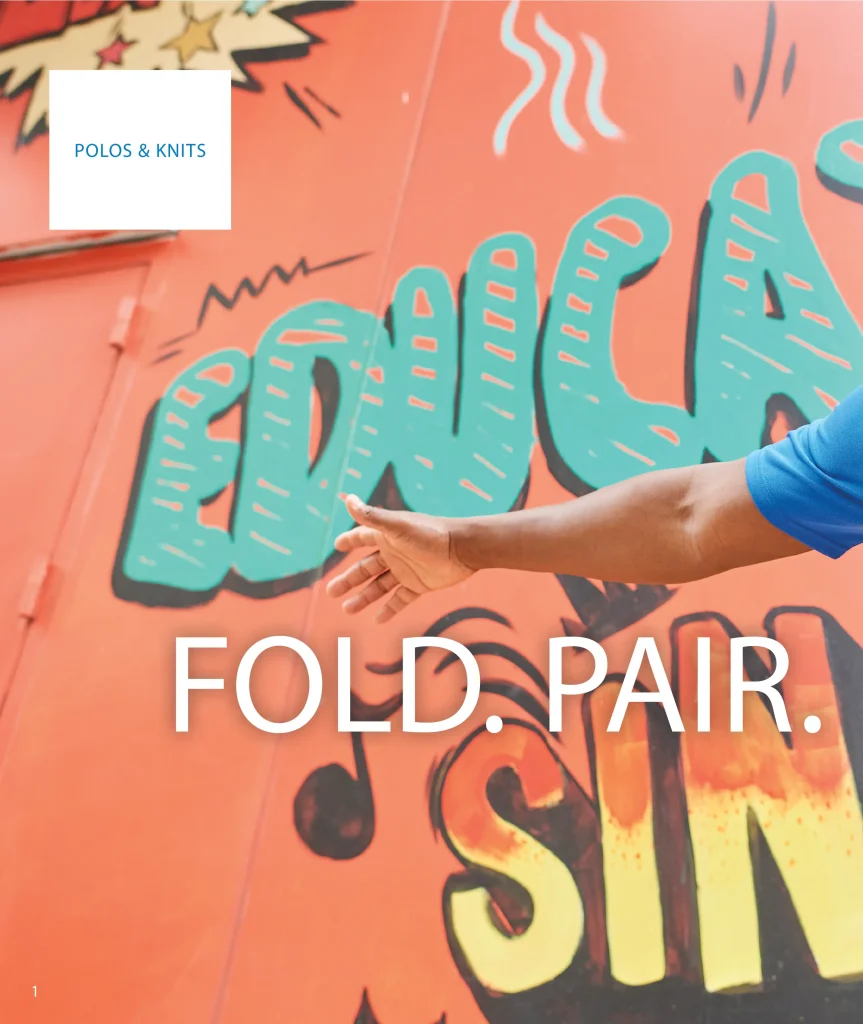 Arm in a royal blue Edwards polo against a colorful mural, Fold. Pair.